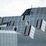 Close-up of a contemporary glass and steel skyscraper facade in an urban setting.