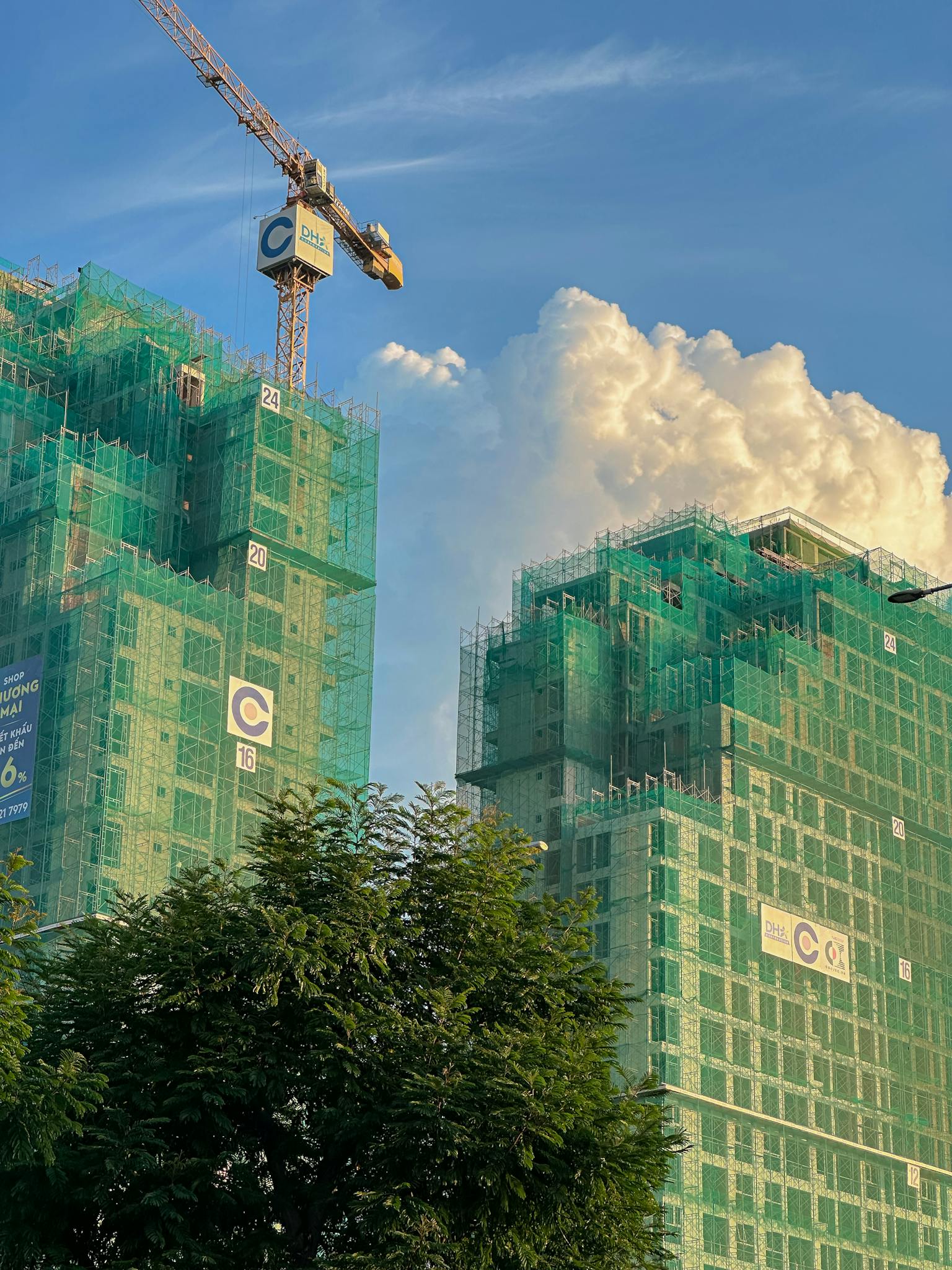 High-rise buildings under construction with cranes in Vietnam, showcasing urban development.